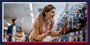 woman looking at school supplies holding a pen and paper 
