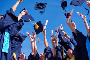 Graduates throwing their caps into the air